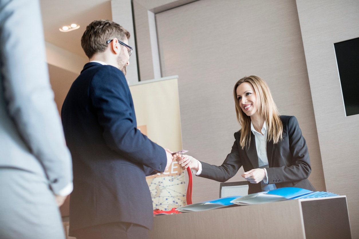 Attendee checking in at an event registration desk