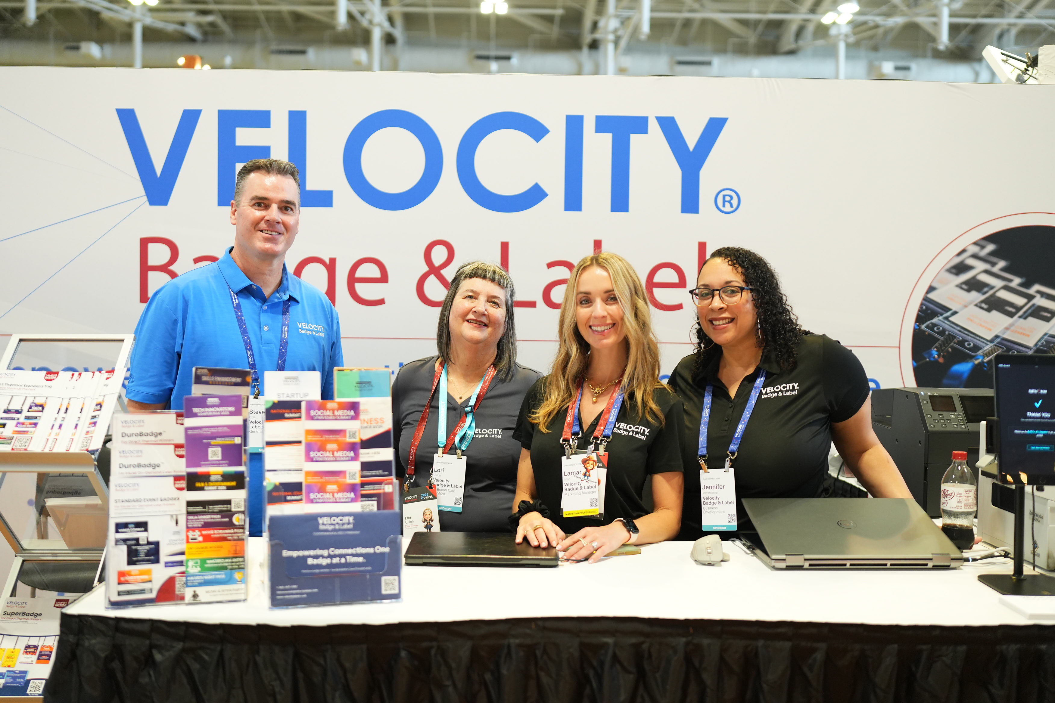 The Velocity Badge & Label team at their trade show booth